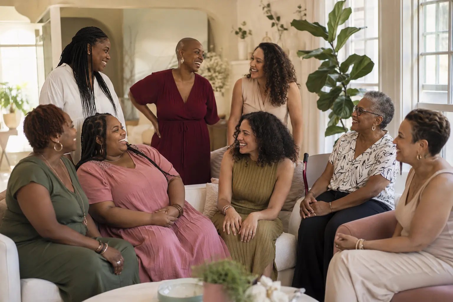 A diverse group of women of different ages, sizes, and backgrounds enjoying conversation and community together