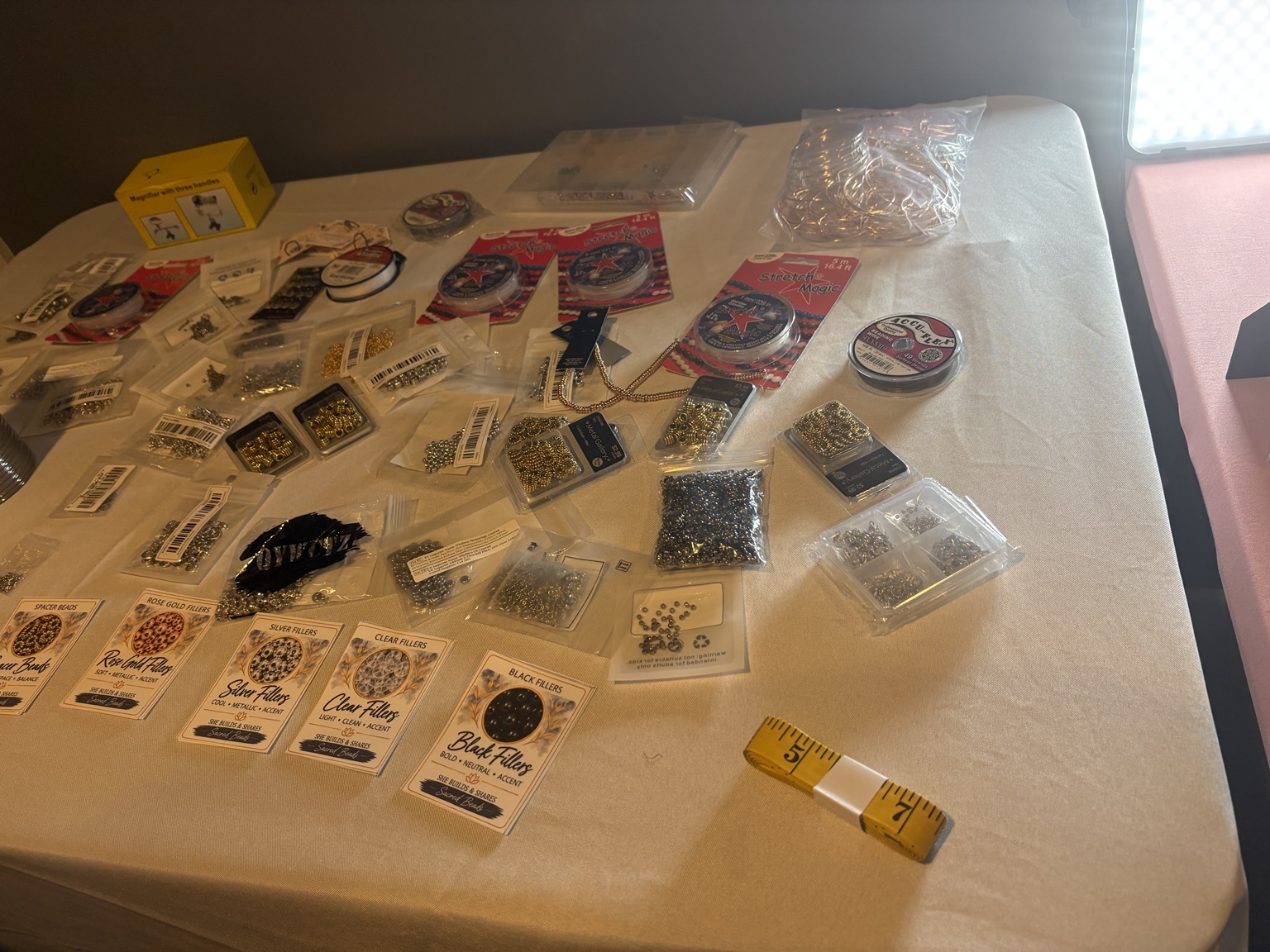Beads, charms, and jewelry-making supplies arranged on a table.